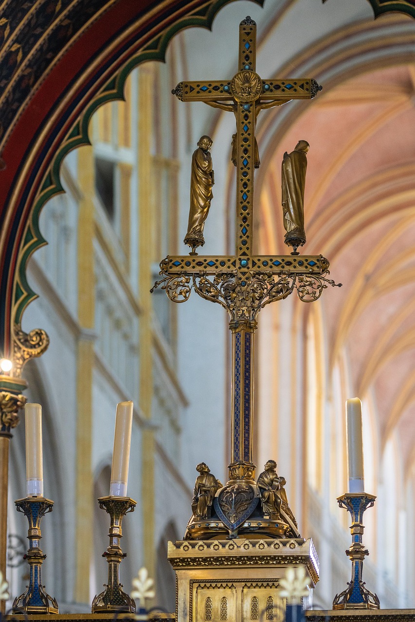 A statue of a gold cross in a church.